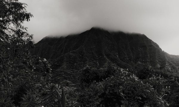 Black-and-white photo of mountain ridge with clouds